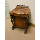 A Victorian walnut davenport with serpentine front 22" wide