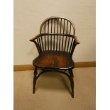 An oak Windsor stick back hooped elbow chair on Crinoline style base
