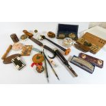 A tray of collectibles to include a Hohner harmonica, paper knife, doorbells,