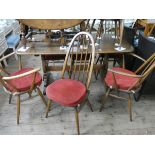 An Ercol Golden Dawn refectory style oak dining table and a set of six stick back Windsor style