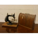 A lead miniature sewing machine in domed case