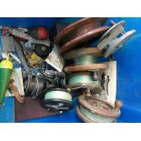 Five large old wooden centre pin fishing reels, one metal centre pin fishing reel,