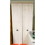 A modern two door light beech wardrobe 2'6 wide