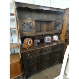 A reproduction oak Welsh style dresser with leaded glazed cabinet back,
