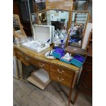 A pale mahogany serpentine front kneehole dressing table with triple mirrors standing on cabriole