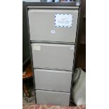 A four drawer metal filing cabinet