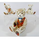 A Royal Crown Derby seated Teddy bear paperweight and two bear figures,