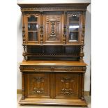 A French carved oak buffet cabinet, the top section with carved centre door,