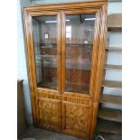 A glazed china display cabinet with walnut panelled cupboard under matching the table and chairs,