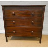 Victorian mahogany chest of three long drawers with bun handles standing on reeded style legs