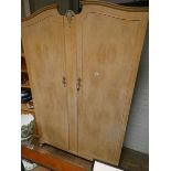 A limed oak two door wardrobe 4' wide