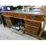A reproduction yew wood twin pedestal desk with green leather top 4'6 wide