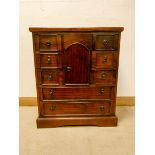 A reproduction mahogany cabinet fitted two long and six small drawers with cupboards centre,