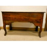 An oak lift top storage chest standing on cabriole legs,