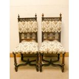 A pair of late Victorian carved oak hall chairs with tapestry upholstered seats and back panels