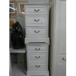 A pair of modern white three drawer bedside chests,