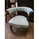 A late Victorian mahogany framed tub shaped elbow chair upholstered in pale blue material with