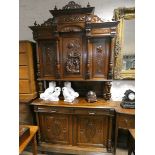 A French highly carved buffet cabinet with cupboard top standing on drawer and cupboard base,