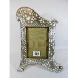 An Edwardian porcelain and white metal mounted photograph frame,