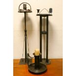Two early 20th century metal smokers pedestals and a metal candlestick