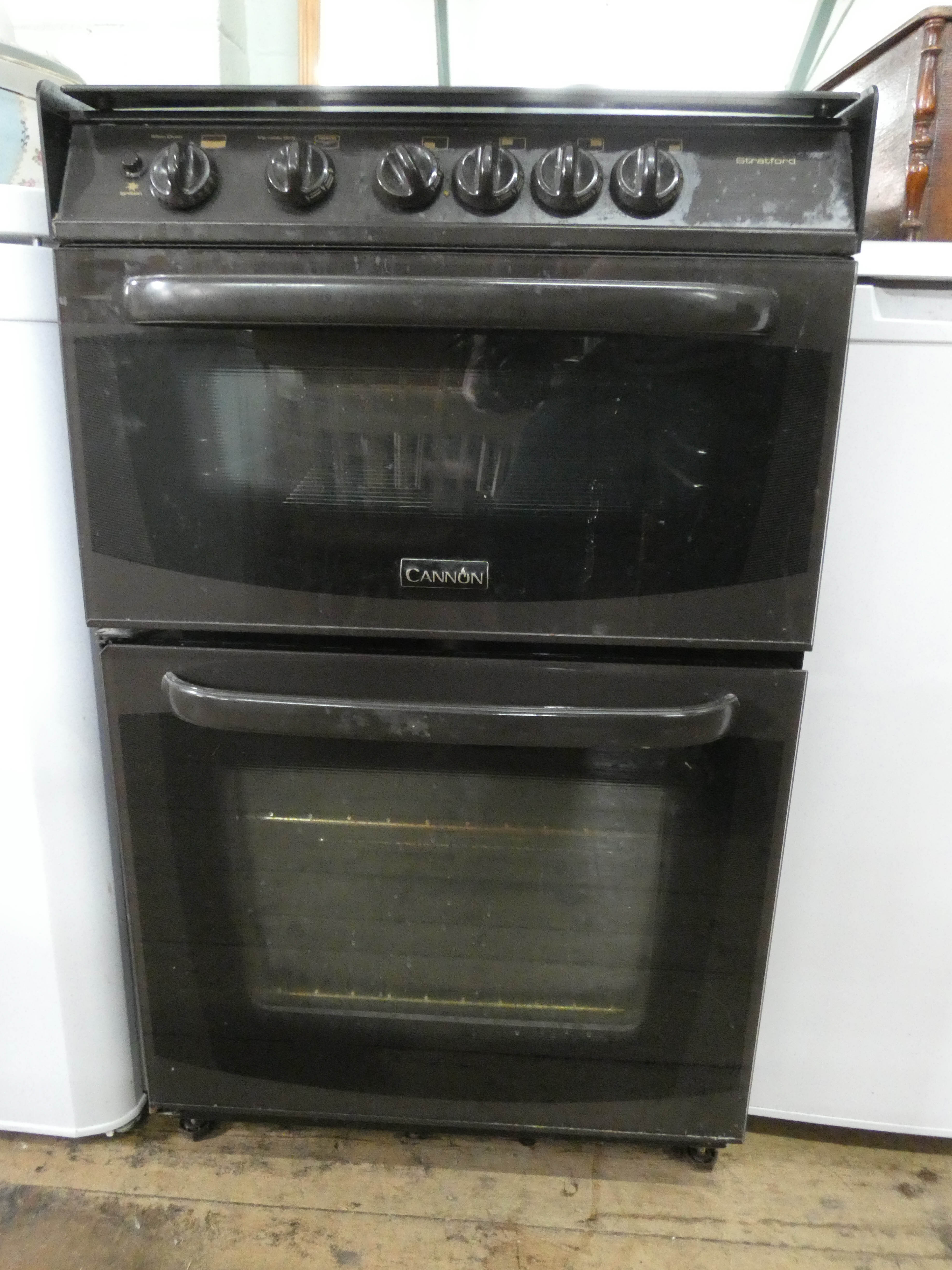 A Cannon four ring gas cooker in brown case with glass cover top