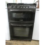 A Cannon four ring gas cooker in brown case with glass cover top