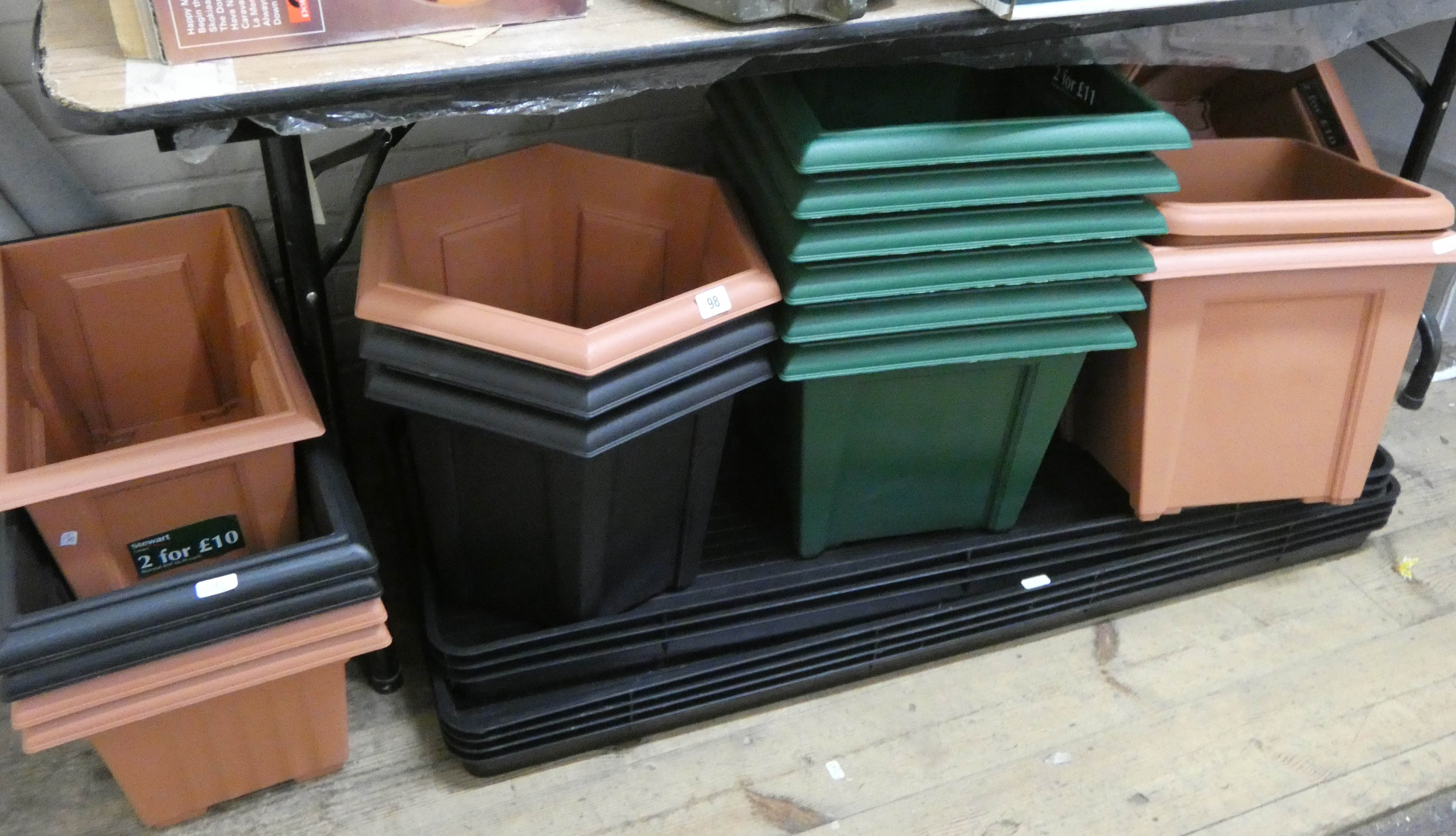 A large collection of square hexagonal plastic plant pots,