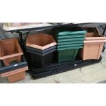 A large collection of square hexagonal plastic plant pots,