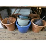 Four circular large clay pots,