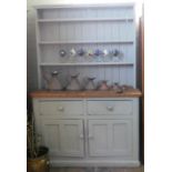A duck egg blue painted pine kitchen dresser with shelf back, drawers and cupboards under,