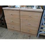 A pair of modern light pine effect three drawer bedside chests