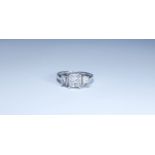 Large modern three stone diamond ring, set with a central princess cut diamond weighing 1.
