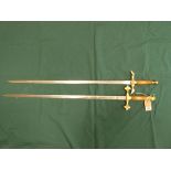 Two wall display swords with brass mounts and wooden handles,