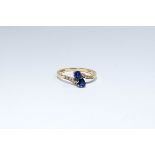 An 18ct sapphire and diamond crossover ring,