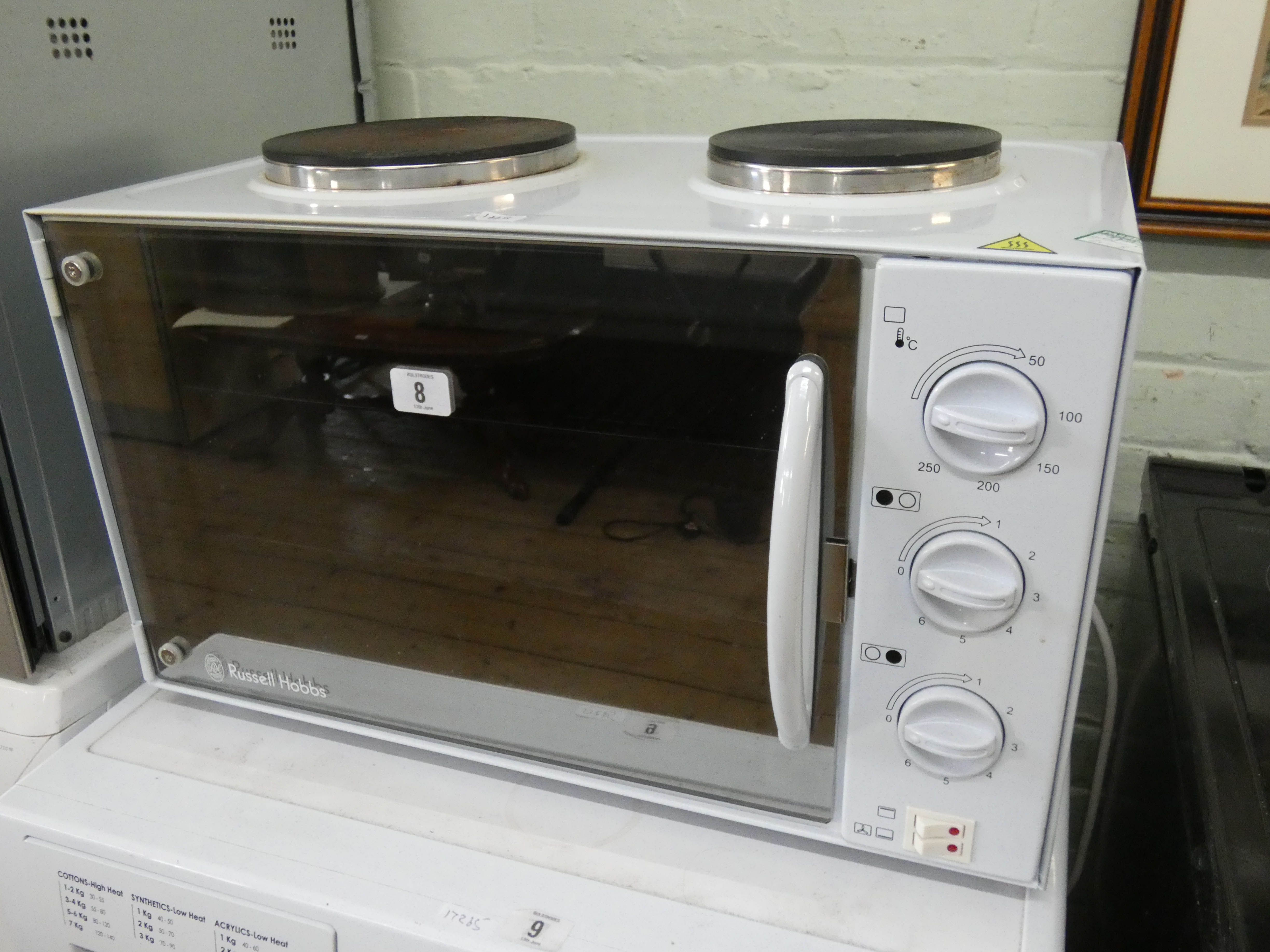 A Russell Hobbs table top grill with two hot plates and mirrored door