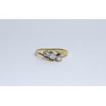 A three stone diamond twist ring set in yellow metal, ring size K 1/2, approximate weight 2.