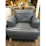 A modern easy chair in dark blue leather
