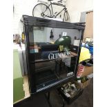 A glass door table top Guinness bottle cooler in black frame