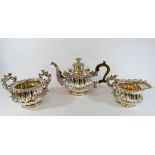 A good quality three piece silver plated tea service with ornate form with wooden handle and rose