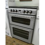 A New Home ceramic to four ring cooker with double oven in silver case