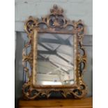 A wall mirror in decorative gilt frame