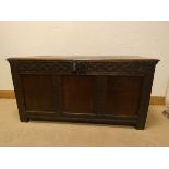 An antique oak three panel coffer with carved boarders,