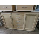 A modern light beech sideboard fitted five centre drawers and cupboards (no shelves),