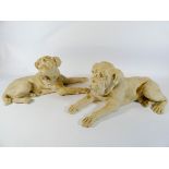 A pair of Parian style recumbent dogs,