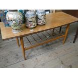 A two tier teak coffee table and a three tier corner shelf