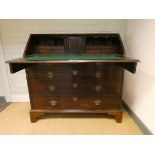 A Georgian mahogany bureau with fitted interior and four long drawers under,
