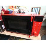 A Delta Microwave oven in a red case