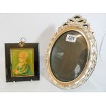 A oval decorative white metal photograph frame and a small portrait miniature in a rectangular