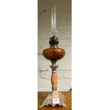 A late Victorian oil lamp with amber glass bowl on an onyx and metal base