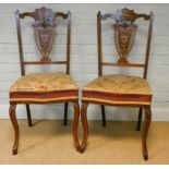 A set of four Edwardian inlaid rosewood dining chairs standing on cabriole legs with upholstered